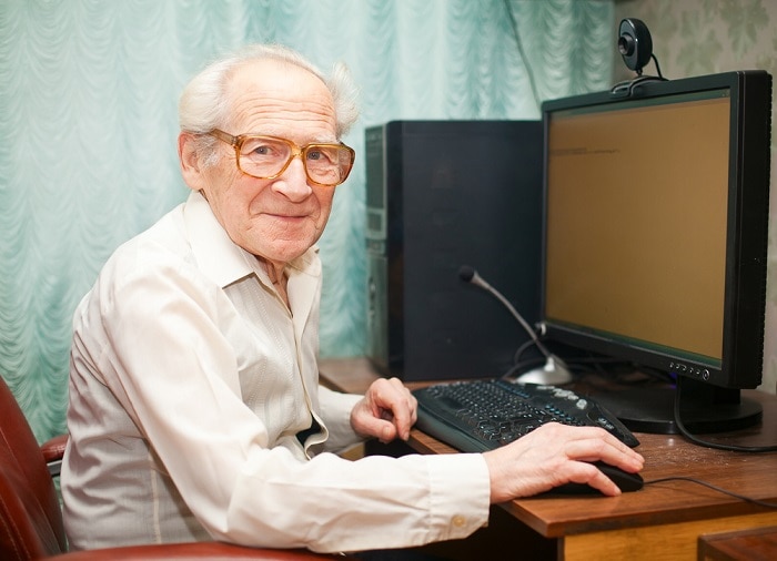 elderly man with computer searching for home care services