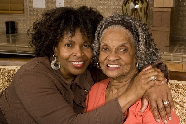 Elderly african american women at home with her caring daughter